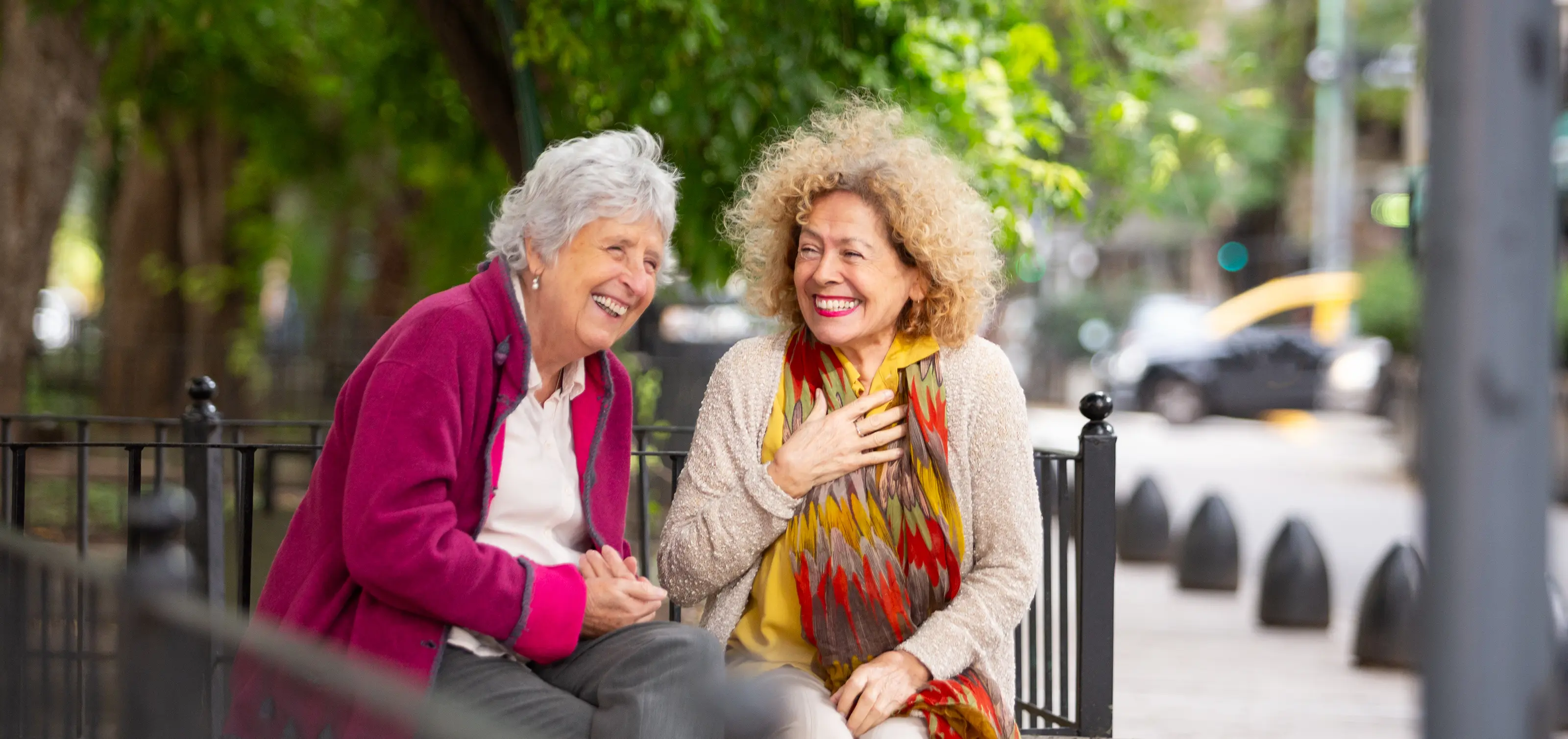Two women sitting outside laughing